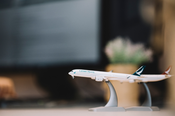 A close-up photograph of a model Cathay Pacific aircraft.