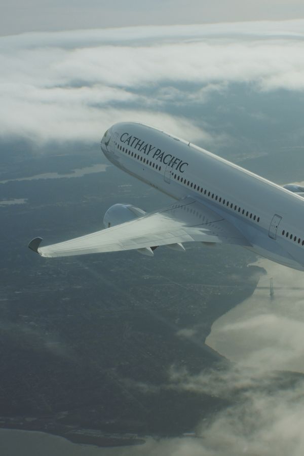 Cathay Pacific airplane flying over Hong Kong.